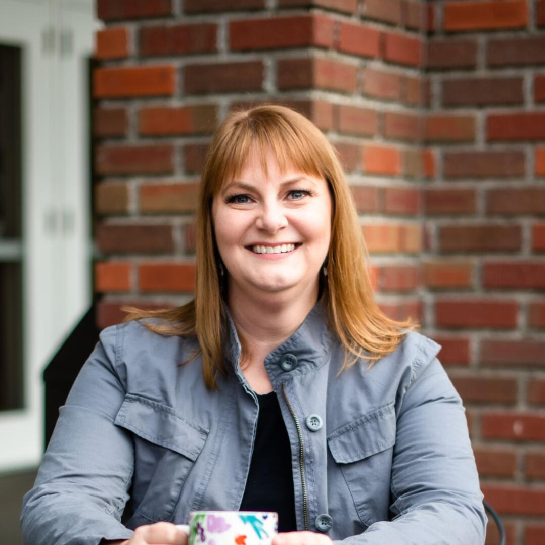 Photo of Jennifer Jim of Renew Therapy NW holding a cup of coffee
